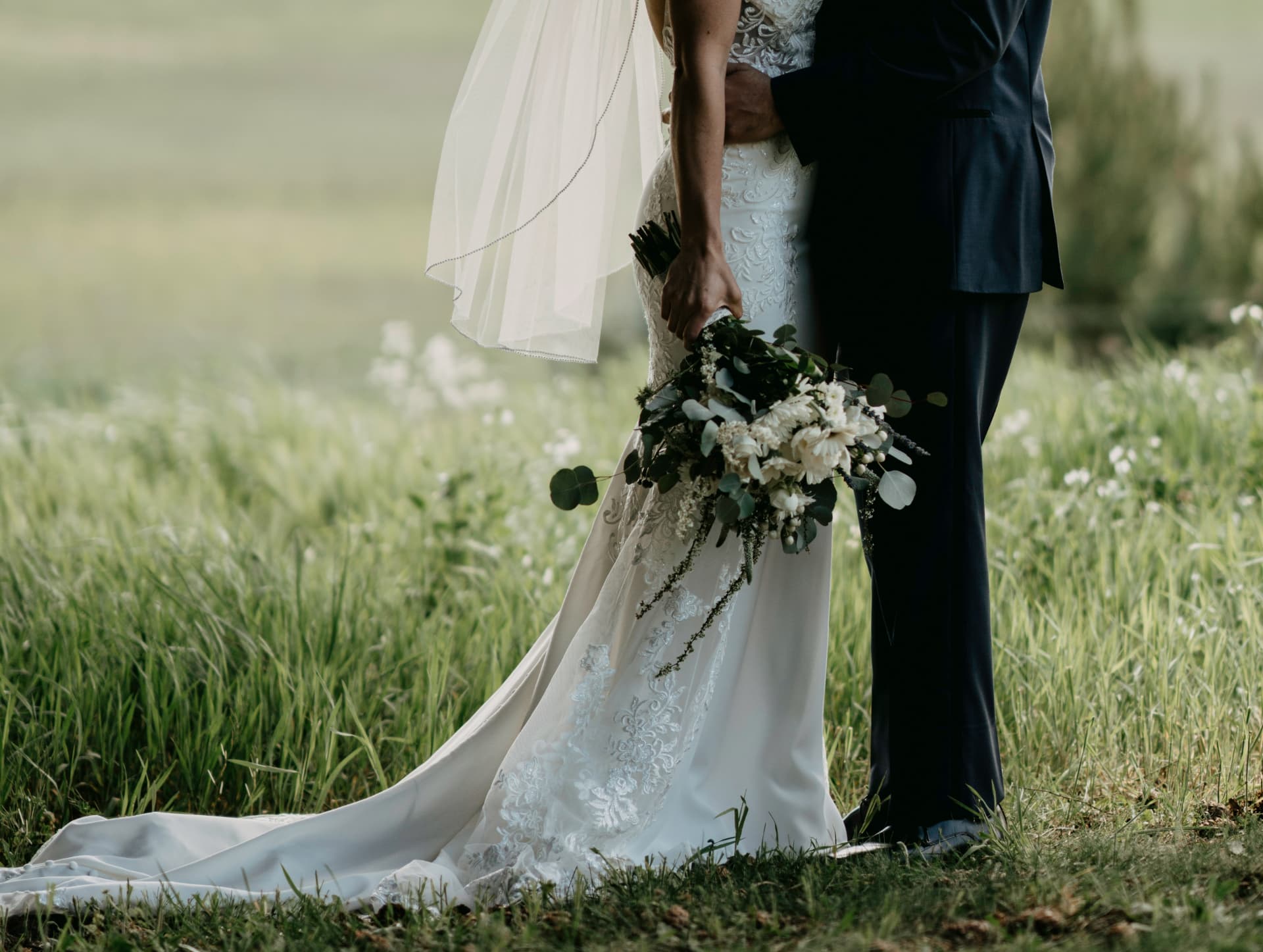 Bride and groom in a summer meadow