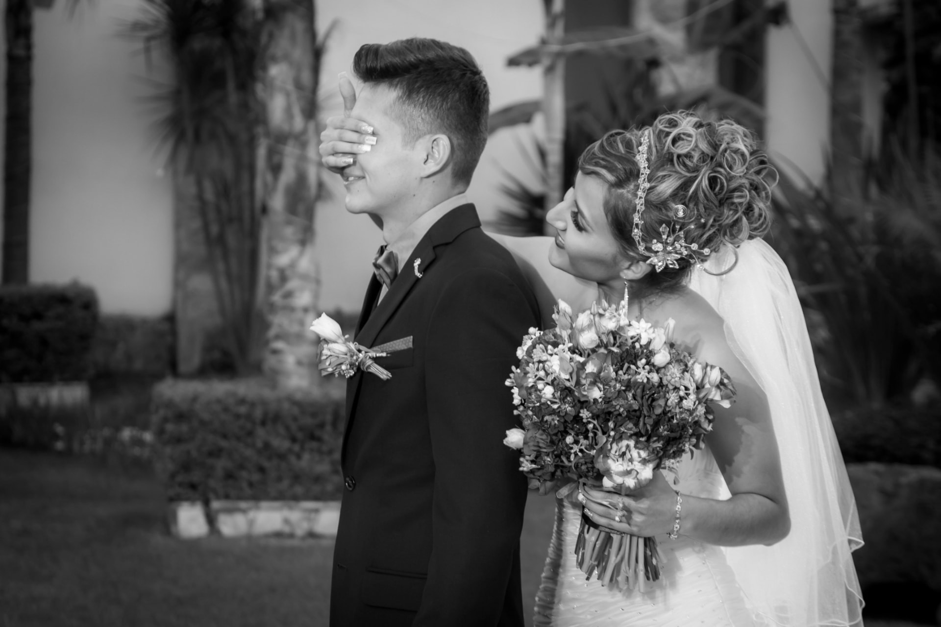Bride covering the groom's eyes